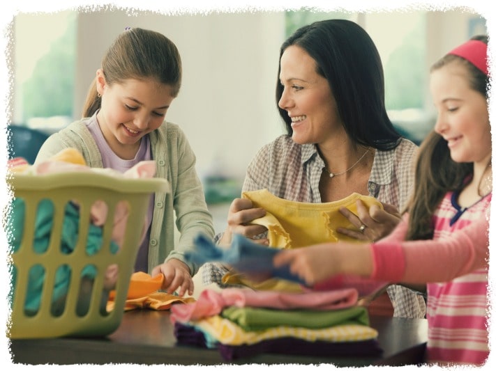 Happy family folding laundry image